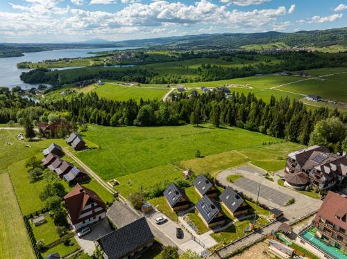 an aerial view of a village with houses and a river at Osada Przystanek Czorsztyn in Czorsztyn