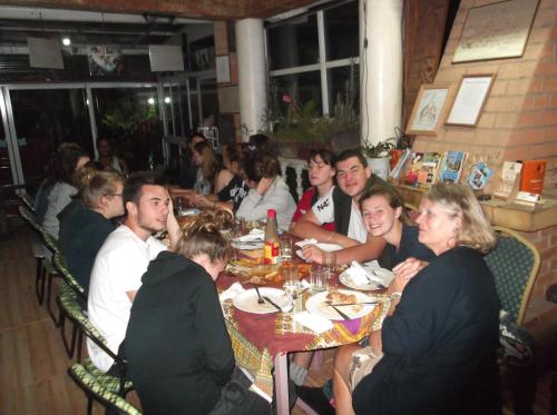 a group of people sitting at a table in a restaurant at Le Karthala Chambres D'Hotes in Antananarivo
