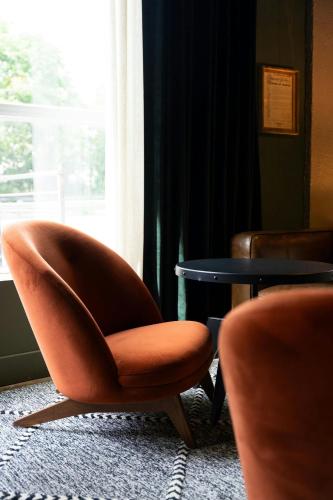 a chair sitting next to a table in a room at Hotel Nell - Union Market in Washington
