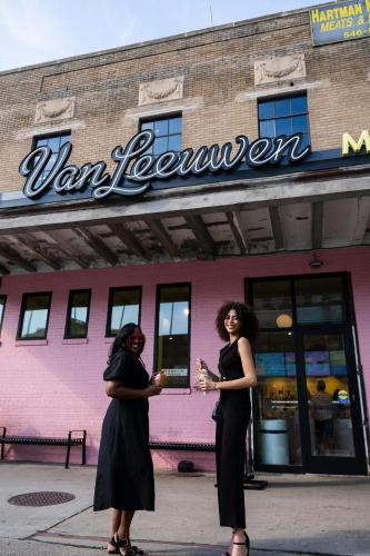 two women standing in front of a building at Hotel Nell - Union Market in Washington
