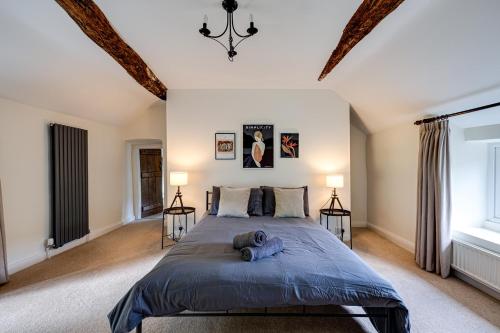a bedroom with a large bed and two lamps at River Fishing I Hot tub I Games Room I PetFriendly in Rainow