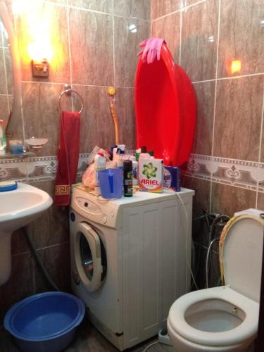 a bathroom with a washing machine and a sink at Nobel Avenue 5 Apartment in Baku