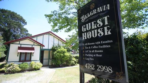 a sign in front of a house with a guest house at Belgravia Mountain Guest House in Katoomba