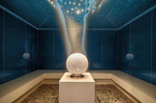 a vase in a room with a blue wall at Kempinski Hotel Grand Arena Bansko in Bansko