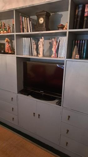 a white entertainment center with a flat screen tv at Casa do Vicente in Tabuaço