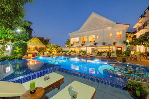 a swimming pool in front of a hotel at Sala Siem Reap Hotel in Siem Reap