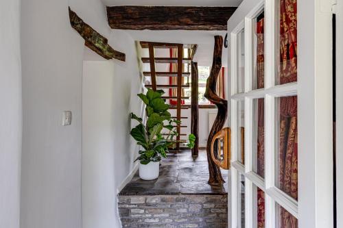 a hallway with a stairway with a plant at River Fishing I Hot tub I Games Room I PetFriendly in Rainow