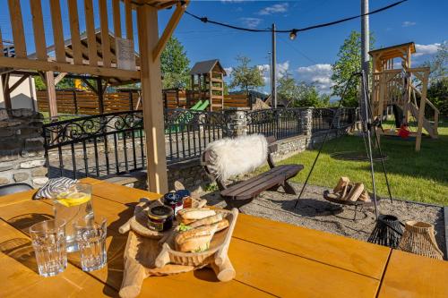 a table with a basket of bread on a patio at Osada Przystanek Czorsztyn in Czorsztyn