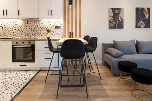 a kitchen with a table and chairs and a couch at Katerina Apartments in Kato Daratso