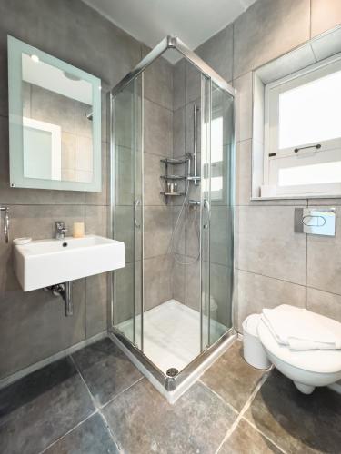 a bathroom with a shower and a sink and a toilet at Unique & Spacious 2BR in Valletta Center by ArcoBnb in Valletta