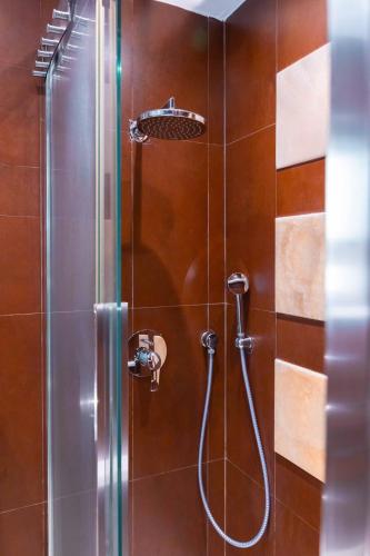 a bathroom with a shower with a glass door at Unique & Spacious 2BR in Valletta Center by ArcoBnb in Valletta