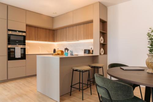 a kitchen and dining room with a table and chairs at Media Bay Apartments in Kirchberg by Rentaroo in Luxembourg