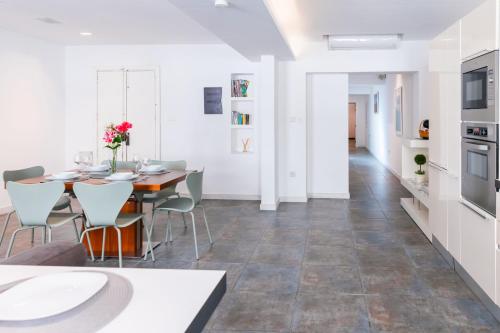 a kitchen and dining room with a table and chairs at Unique & Spacious 2BR in Valletta Center by ArcoBnb in Valletta