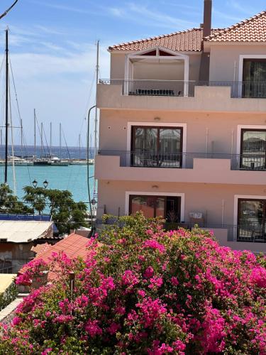 a building with pink flowers in front of it at AMINA APARTMENTS in Zakynthos Town