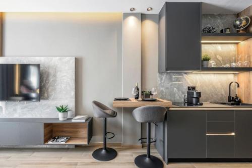 a kitchen with two bar stools and a counter at Aristotelian Virtues - Sophia in Thessaloniki