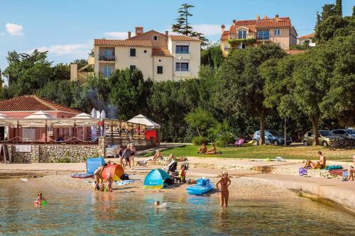 a group of people in the water at a beach at Apartment Jelka 1 in Krk