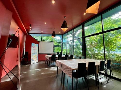 a conference room with tables and chairs and a whiteboard at Green@Buriram in Buriram