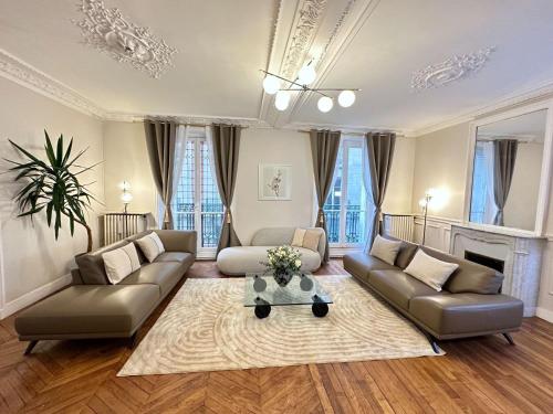 un salon avec deux canapés et une cheminée dans l'établissement Luxurious Home in Le Marais, à Paris