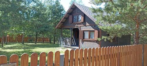 a small house behind a wooden fence at Nasze Podlasie, Domek w Dubiczach Cerkiewnych in Dubicze Cerkiewne