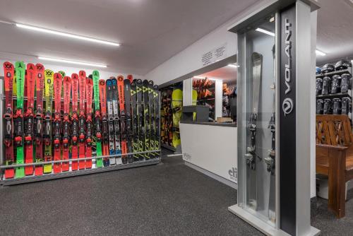 a store with a bunch of snowboards on the wall at Kempinski Hotel Grand Arena Bansko in Bansko