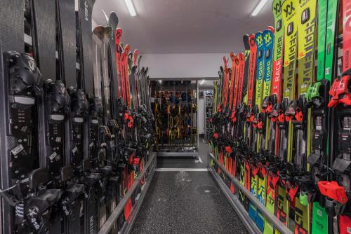 a bunch of skis are lined up in a store at Kempinski Hotel Grand Arena Bansko in Bansko