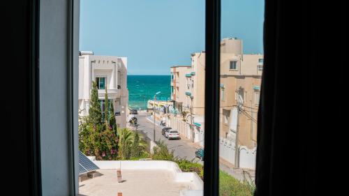 a view from a window of a street and the ocean at Vip House Résidence in Sousse