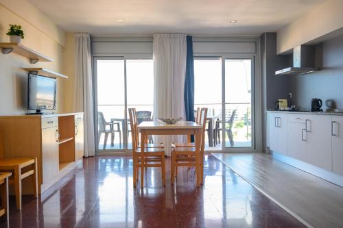 a kitchen and dining room with a table and chairs at Albatros Family in Salou