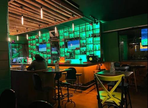 a person sitting at a bar in a restaurant at West Pera Hotel in Istanbul