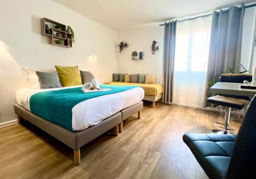 a bedroom with a bed and a couch and a piano at Hotel L'Escapade in Le Lavandou