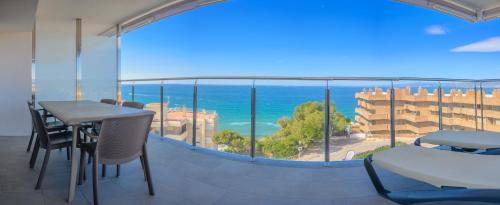 a balcony with a table and chairs and a view of the ocean at Albatros Family in Salou