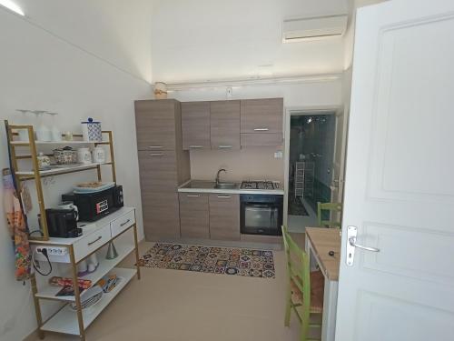 a small kitchen with a sink and a stove at TETIDE Holiday home,casa vacanze in Trapani