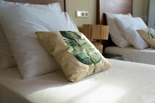 a pillow sitting on top of a bed at Couleur Locale Paramaribo in Paramaribo