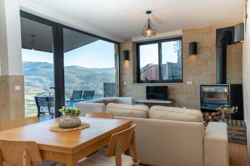 a living room with a couch and a table at Casas das Olas in Arcos de Valdevez