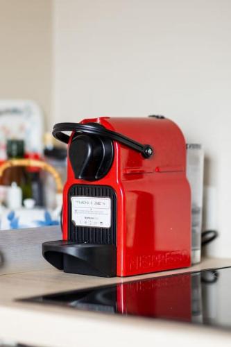 a red toaster sitting on top of a counter at Le petit chapitre in Fosses-La-Ville