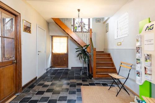 a hallway with a staircase and a stair case at Le petit chapitre in Fosses-La-Ville