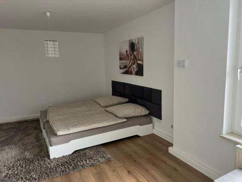 a bedroom with a bed in a white room at Schöne und sehr zentrale Wohnung im Herzen von Gelsenkirchen in Gelsenkirchen
