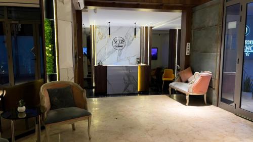 a lobby with two chairs and a stage in a building at Vip House Résidence in Sousse