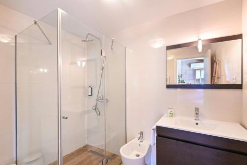 a bathroom with a shower and a sink and a toilet at Casas das Olas in Arcos de Valdevez