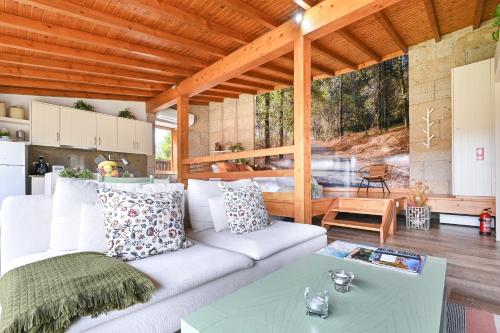 a living room with a white couch and a table at Casas das Olas in Arcos de Valdevez