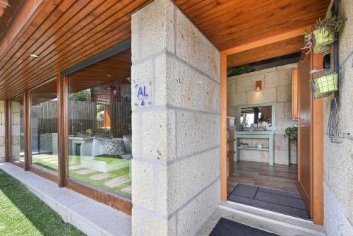 an external view of a house with a large glass door at Casas das Olas in Arcos de Valdevez