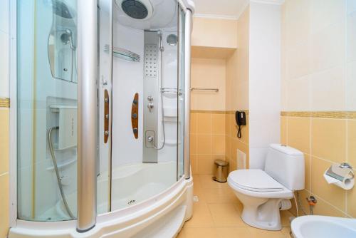 a bathroom with a shower and a toilet at Sovinyon Resort in Odesa