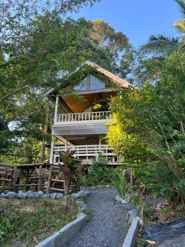 a house with a balcony in the middle of trees at The Hidden Gem Viewpoint Camping & Rooms in Ban Nok