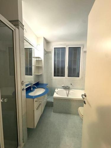 a bathroom with a sink and a tub and a toilet at Apartment in Luxury District in Genova