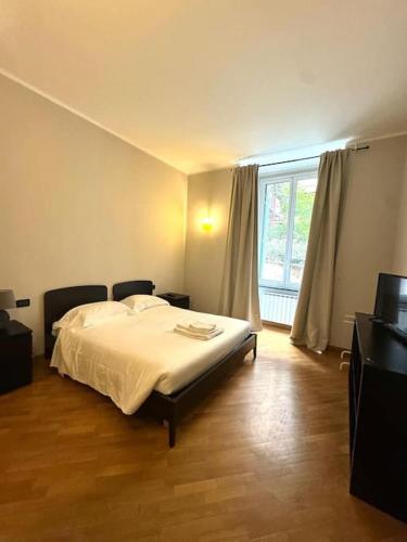 a bedroom with a bed and a large window at Apartment in Luxury District in Genova
