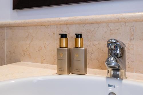 two bottles ofodorizers sitting on a counter next to a sink at Spacious 2-bed apt Capanes del Golf in Benahavís