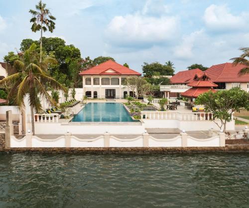 an exterior view of a house with a swimming pool at Taj Malabar Resort & Spa, Cochin. in Cochin