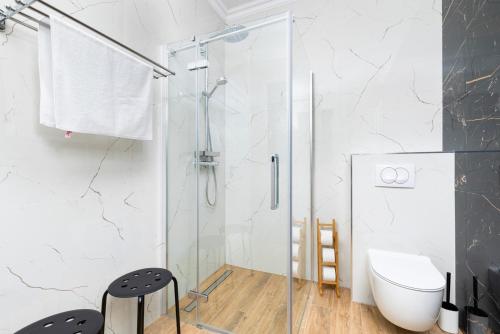 a glass shower in a bathroom with a toilet at Villa Laura in Malinska