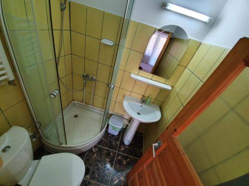 a bathroom with a toilet a sink and a shower at Eforie Brio in Eforie Nord