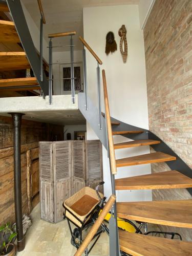 a winding staircase in a room with a brick wall at dd Chalet in Aitrach
