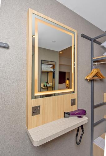 a mirror on a wall in a room at Premier Inn Dubai International Airport in Dubai